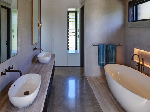 A modern bathroom interior with polished concrete flooring